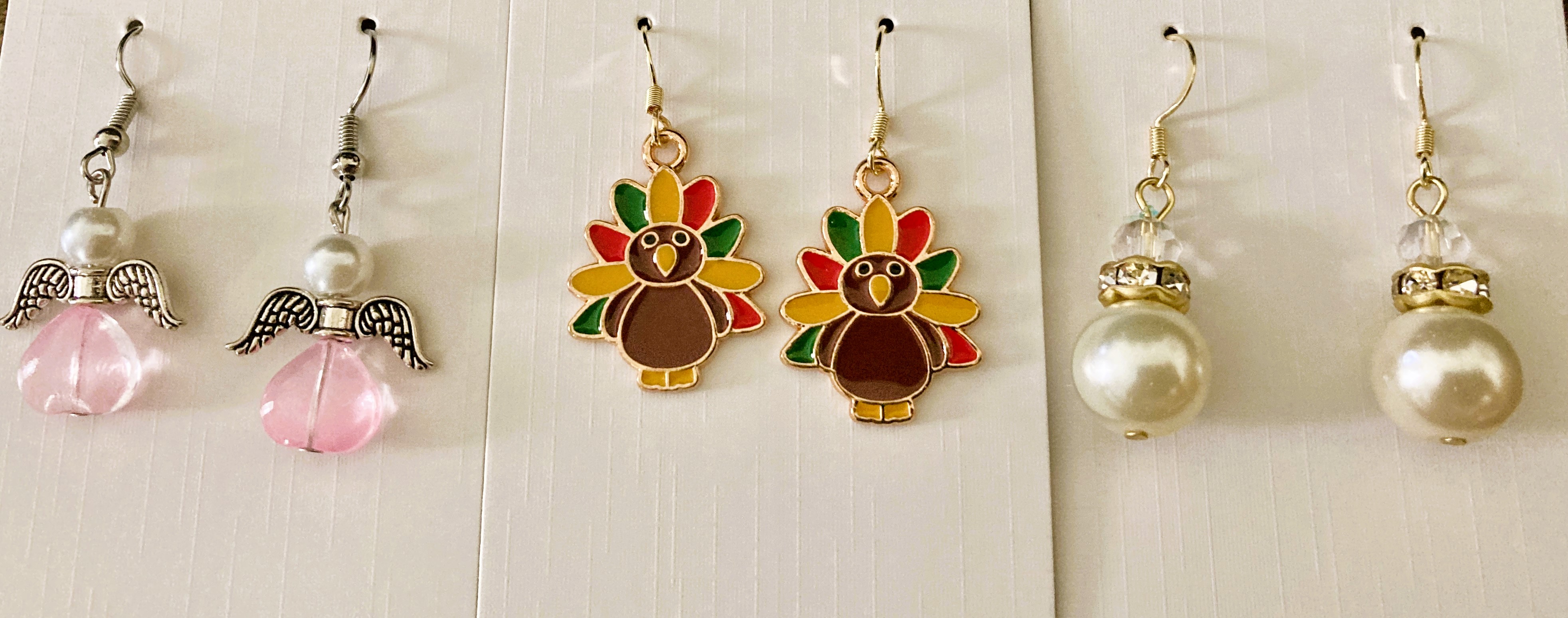 Three pairs of holiday earrings.